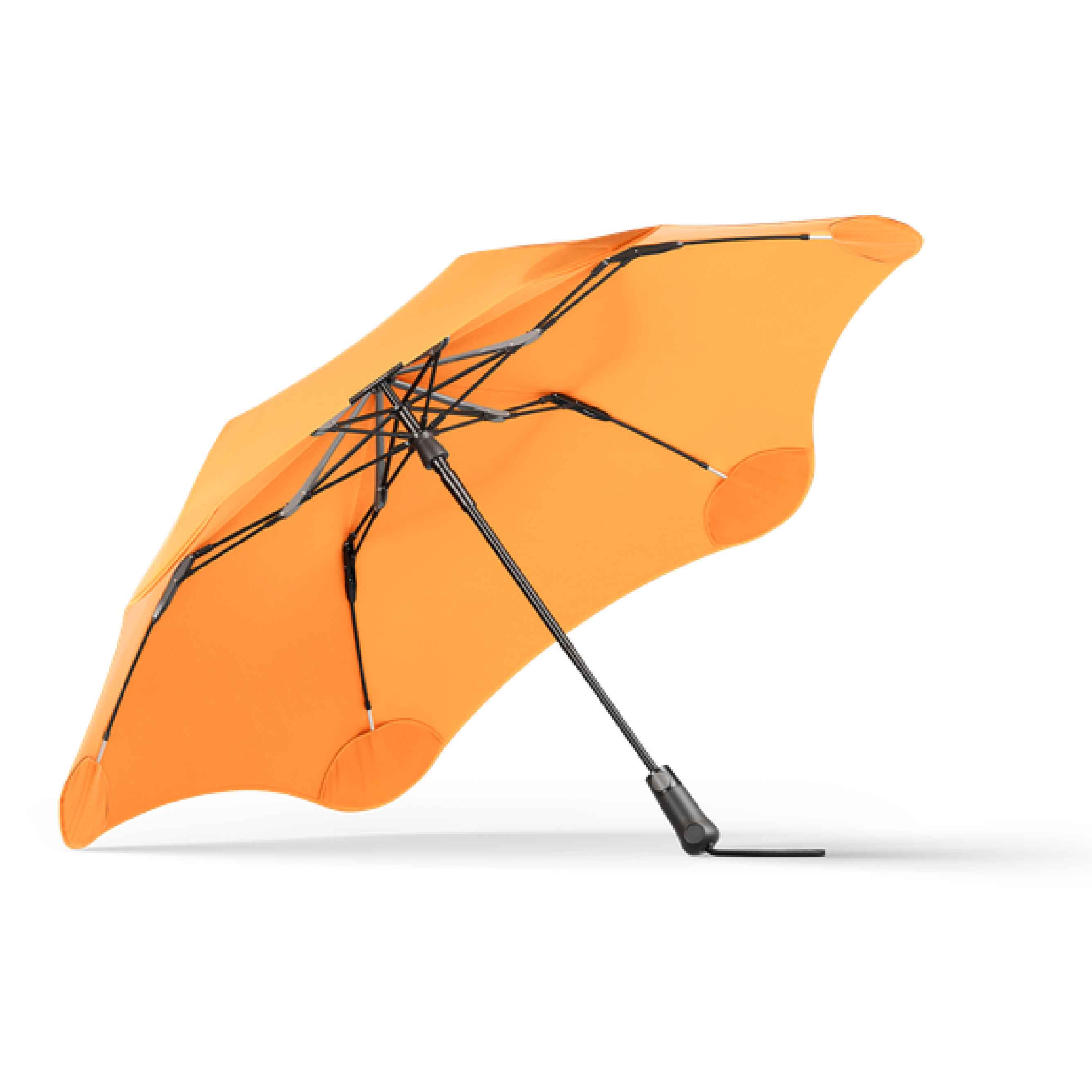 Compact folded Blunt Umbrella Metro in Mango Orange, easy to carry, collapsible.