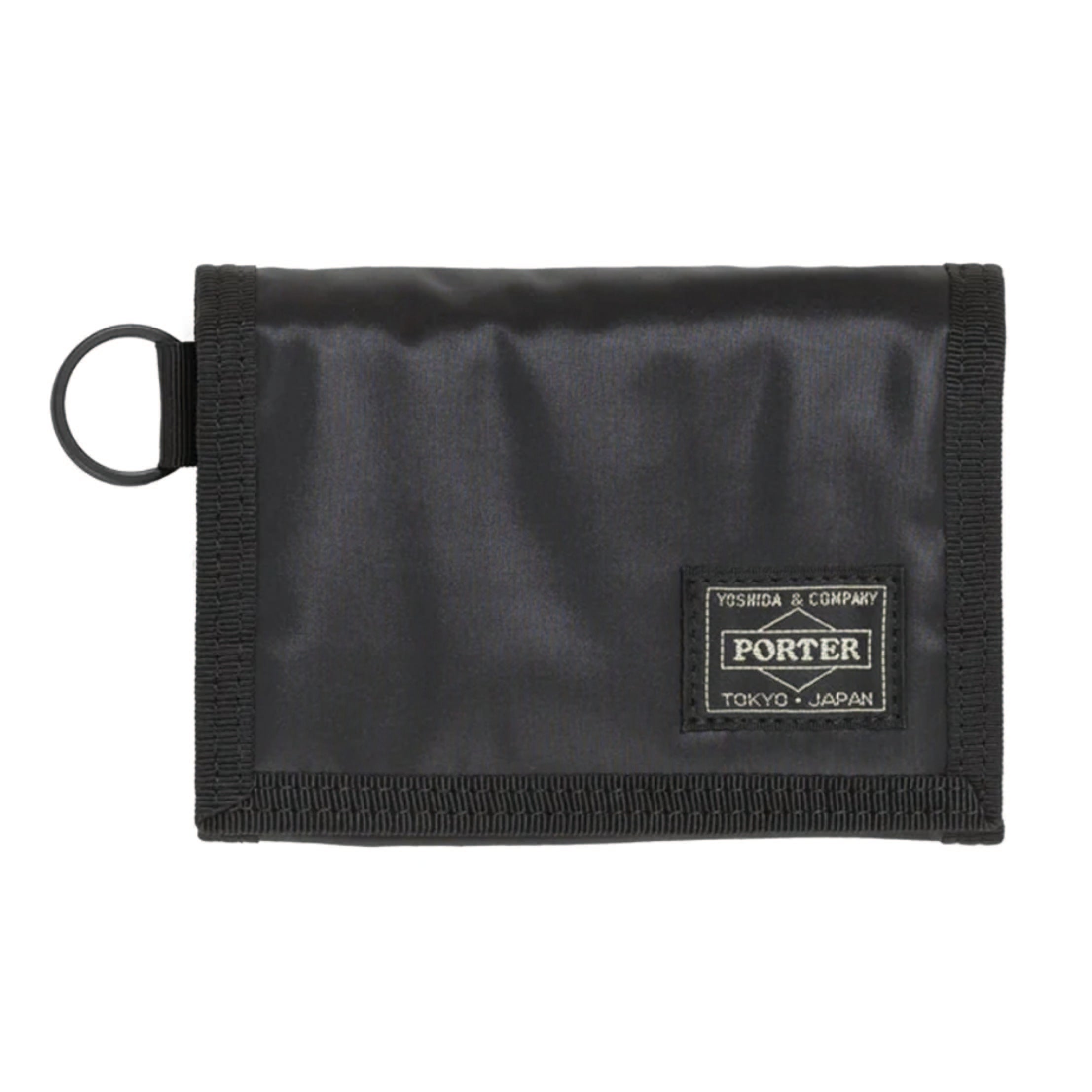 Porter Yoshida & Co. Capsule Wallet in black — front view showing compact zip-around form and embossed Porter branding